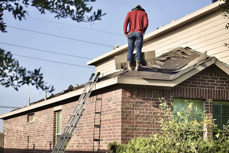 Professional roofer working on a residential roof in Cobbs Village
